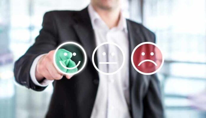Businessperson selecting a happy face rating icon