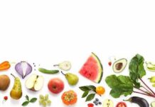 The one fruit that might keep the diabetes doctor away Assorted fresh fruits and vegetables arranged along the bottom on white