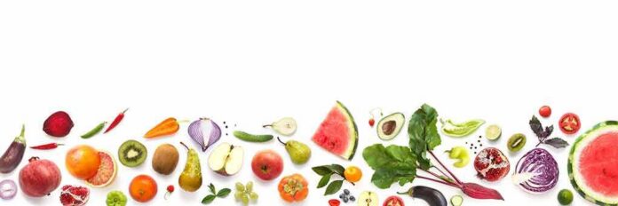 Assorted fresh fruits and vegetables arranged along the bottom on white