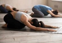 Group of people in child's pose during a yoga class