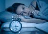 Sleepless PTSD? Mayo Drops a Playbook Woman lying awake in bed beside an alarm clock