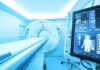 MRI or CT scanner with control monitor in hospital room