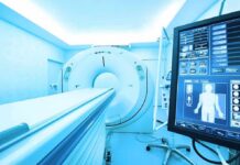 MRI or CT scanner with control monitor in hospital room