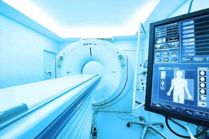 MRI or CT scanner with control monitor in hospital room