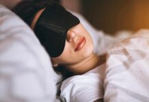 How to beat insomnia without taking pills Woman sleeping with a black eye mask in bed