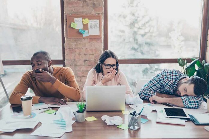 1783890377051-n7bw31-shutterstock-1050022058 tired coworkers at a cluttered desk