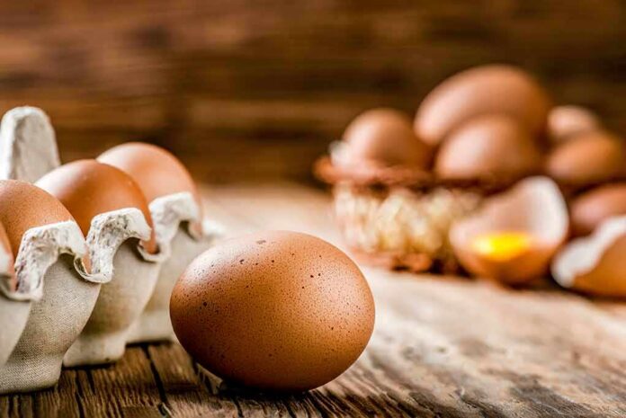 Brown eggs on rustic wooden table