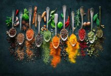Kitchen Spice Humbles Cancer Cells Assorted spices in vintage spoons on dark background