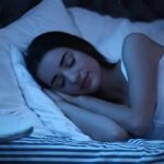 What to be eating for a better night’s sleep Woman sleeping on her side in bed