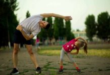 Man and young girl stretching outdoors