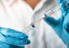 Gray-Market Peptides Get A Shocking Green Light Gloved hands drawing liquid into a syringe from a vial