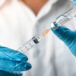 Gray-Market Peptides Get A Shocking Green Light Gloved hands drawing liquid into a syringe from a vial