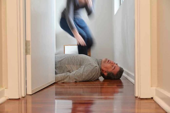 Man lying unconscious on hallway floor