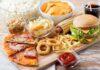 Assorted fast food on a wooden board