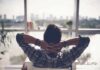 Person relaxing in chair facing large window
