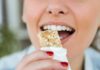 Protein Bars’ Hidden Heart Hit Person taking a bite of a granola bar