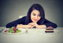 Woman choosing between salad and chocolate cake