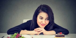 Woman choosing between salad and chocolate cake