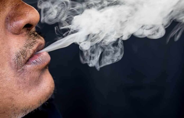 shutterstock_668061646 Close-up of a person exhaling smoke